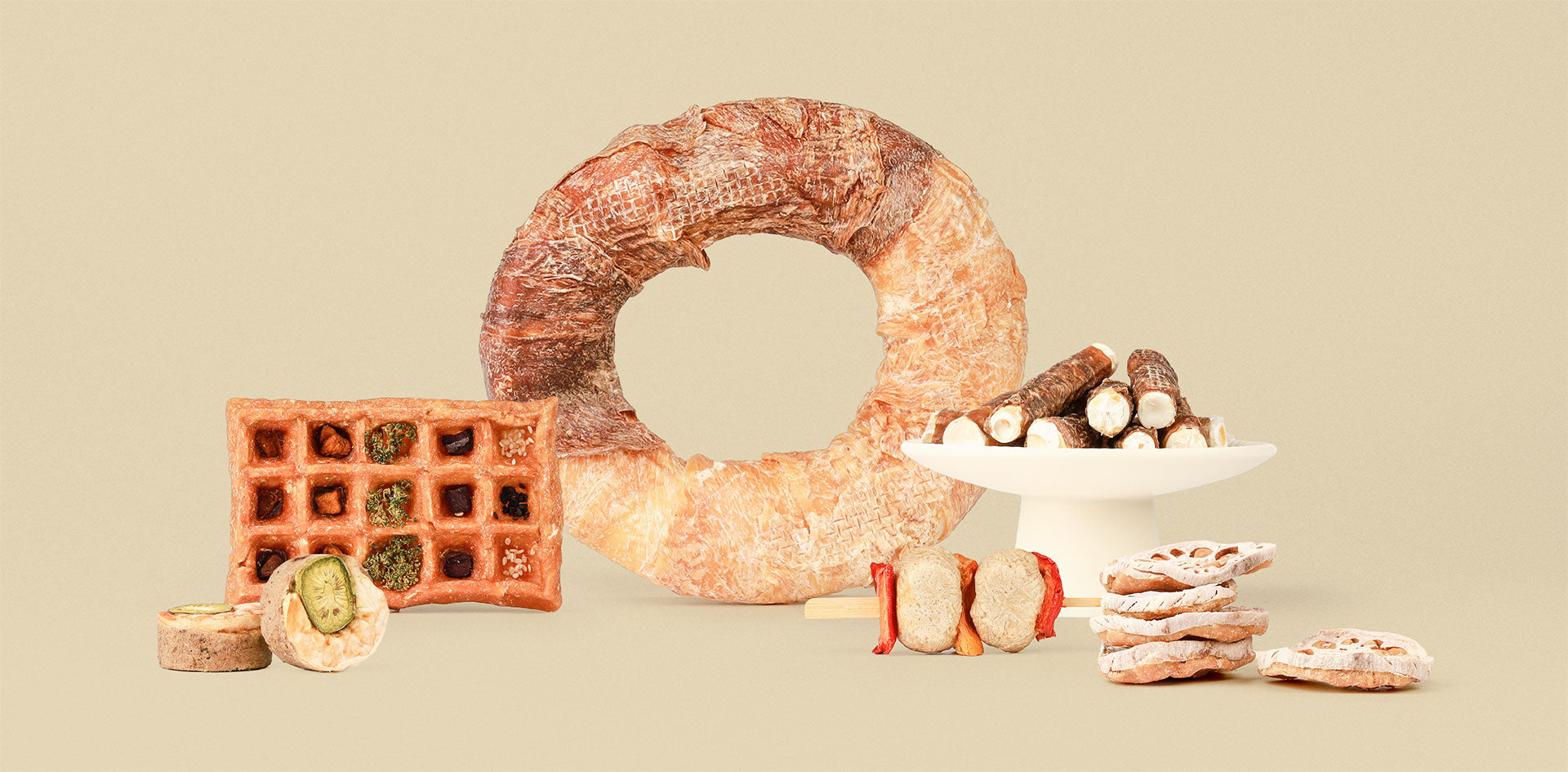 Assortment of ChewTrue natural dog treats, including beefhide rings, chicken waffles, and meat skewers.